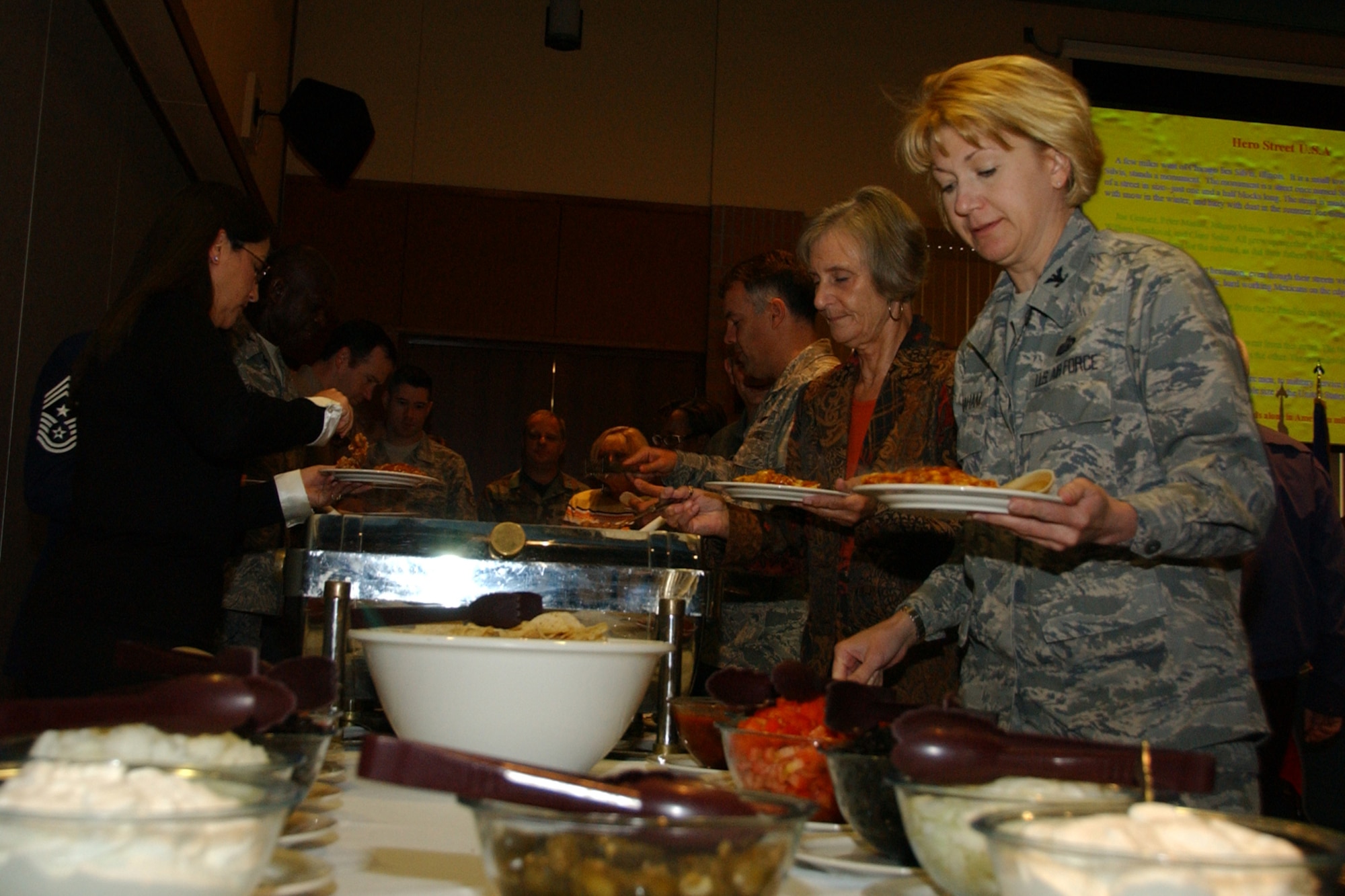 Col. Jennifer Graham, 71st Mission Support Group commander, samples the food at Team Vance's National Hispanic American Heritage luncheon Oct. 14 at the Vance Collocated Club. About 60 people attended the luncheon. U.S. Air Force photo by Staff Sgt. Brian Hill.