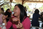 Airman Marylou Gomez, 12th Mission Support Squadron, enjoys conversation and a turkey leg at Ocktoberfest 2008 at Eberle Park Oct. 10. Airmen, coworkers, family members and supervisors spent the day celebrating enlisted Airmen for their contributions to the Air Force and Nation. (U.S. Air Force photo by Rich McFadden)