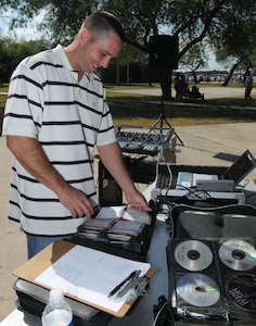 Master Sgt. Larry Sampsell, Air Education and Training Command, picks out music to play at Ocktoberfest 2008 at Eberle Park on Oct. 10. Airmen, coworkers, family members and supervisors spent the day celebrating enlisted Airmen for their contributions to the Air Force and Nation. (U.S. Air Force photo by Rich McFadden)