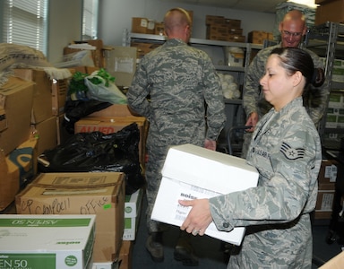 Staff Sgt. Amy Larsen, 12th Flying Training Wing Chaplain Office, moves boxes Oct. 10 in preparation for a move from the Chapel annex to the Taj Mahal, Bldg. 100. The chapel business offices are moving to accommodate Operational Readiness Inspection inspectors. (U.S. Air Force photo by Rich Mc Fadden)