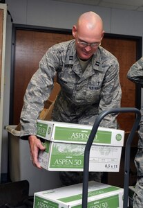 Chaplain (Capt.) Eric Boyer, with the 12th Flying Training Wing Chaplain Office, loads paper bundles on a dolly Oct. 10 in preparation for a move from the Chapel annex to the Taj Mahal, Bldg. 100. The chapel business offices are moving to accommodate Operational Readiness Inspection inspectors. (U.S. Air Force photo by Rich Mc Fadden)