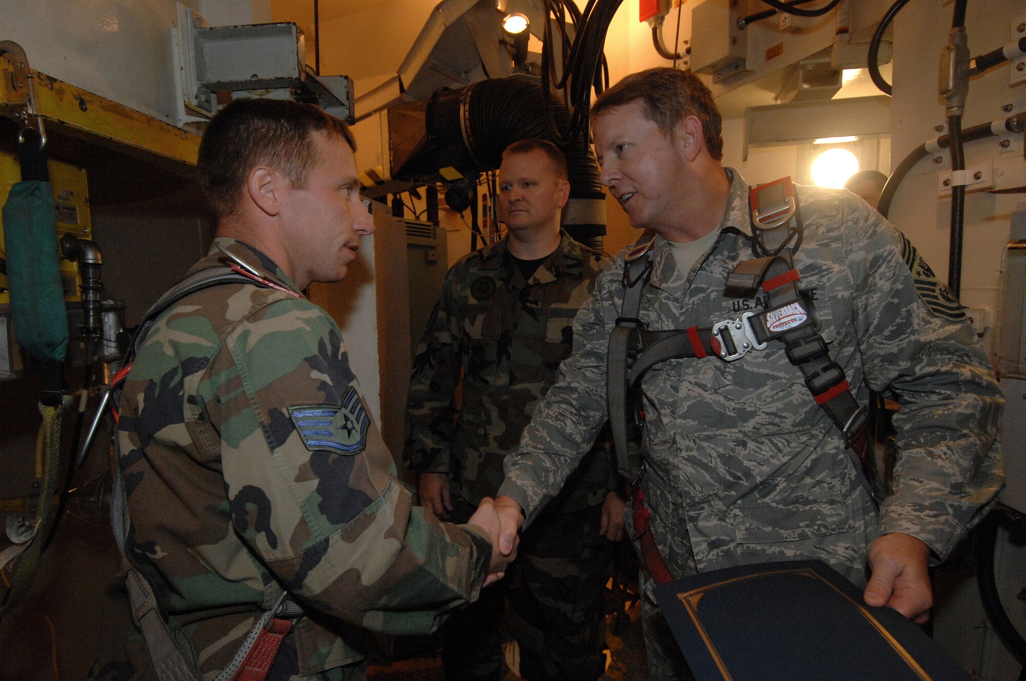 MINOT AIR FORCE BASE, N.D. -- Chief Master Sgt. of the Air Force Rodney J. McKinley (right) shakes the hand of Staff Sgt. Donald Waugh, 91st Maintenance Operations Squadron, following his tour of the launch facility trainer Uniform One during his visit here Oct. 8 to 10. Chief McKinley’s three-day visit marks his first trip to Minot AFB as CMSAF to meet Airmen from the 5th Bomb Wing and the 91st Missile Wing. Chief McKinley is the 15th chief master sergeant appointed to the highest noncommissioned officer position in the Air Force. (U.S. Air Force photo by Senior Airman Kelly Timney)