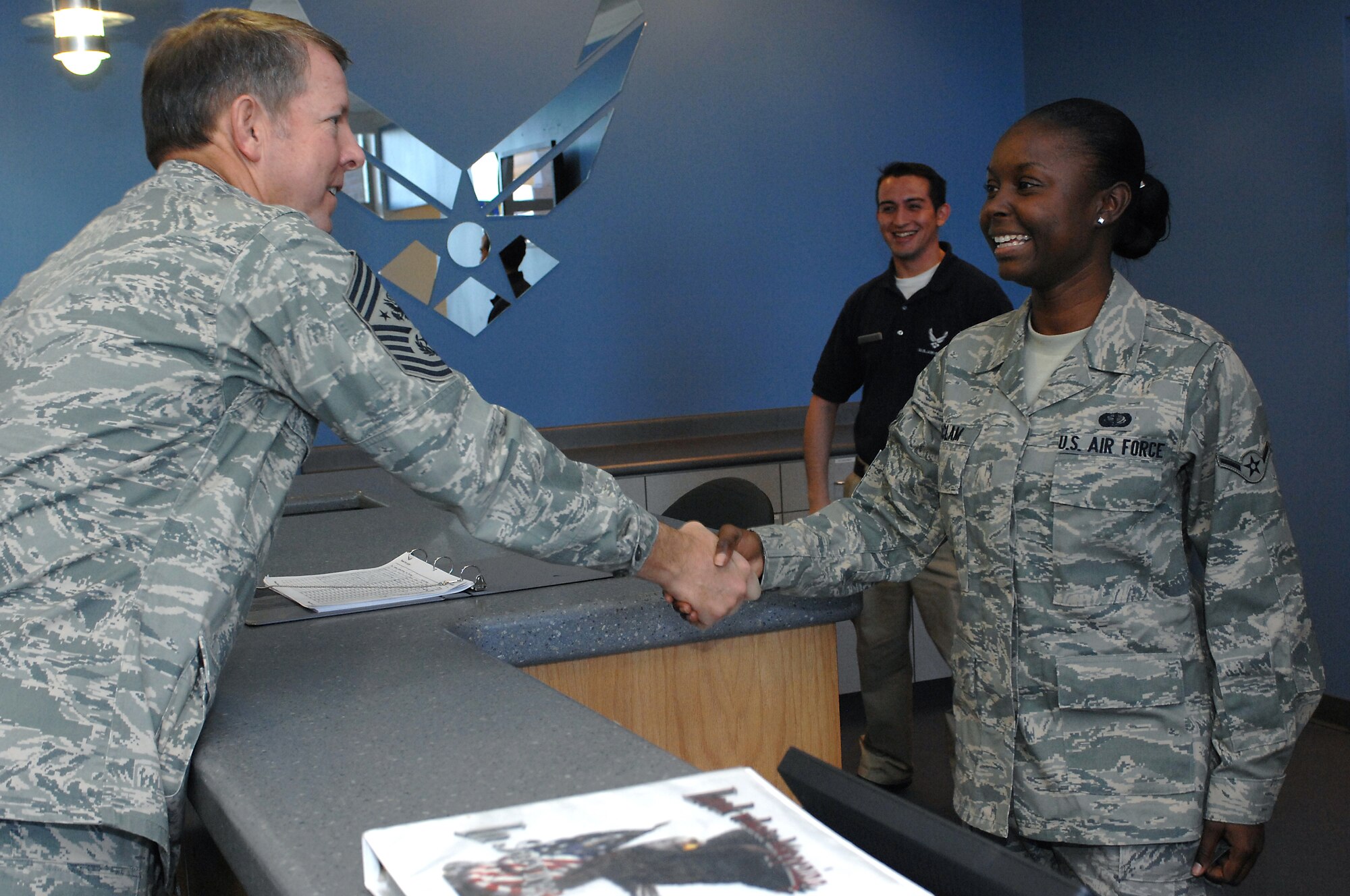 MINOT AIR FORCE BASE, N.D. -- Chief Master Sgt. of the Air Force Rodney J. McKinley (left) congratulates Airman Chianti McClam, 5th Force Support Squadron, for receiving her first stripe during his visit here Oct. 8 to 10. Chief McKinley’s three-day visit marks his first trip to Minot AFB as CMSAF to meet Airmen from the 5th Bomb Wing and the 91st Missile Wing. Chief McKinley is the 15th chief master sergeant appointed to the highest noncommissioned officer position in the Air Force. (U.S. Air Force photo by Senior Airman Kelly Timney)