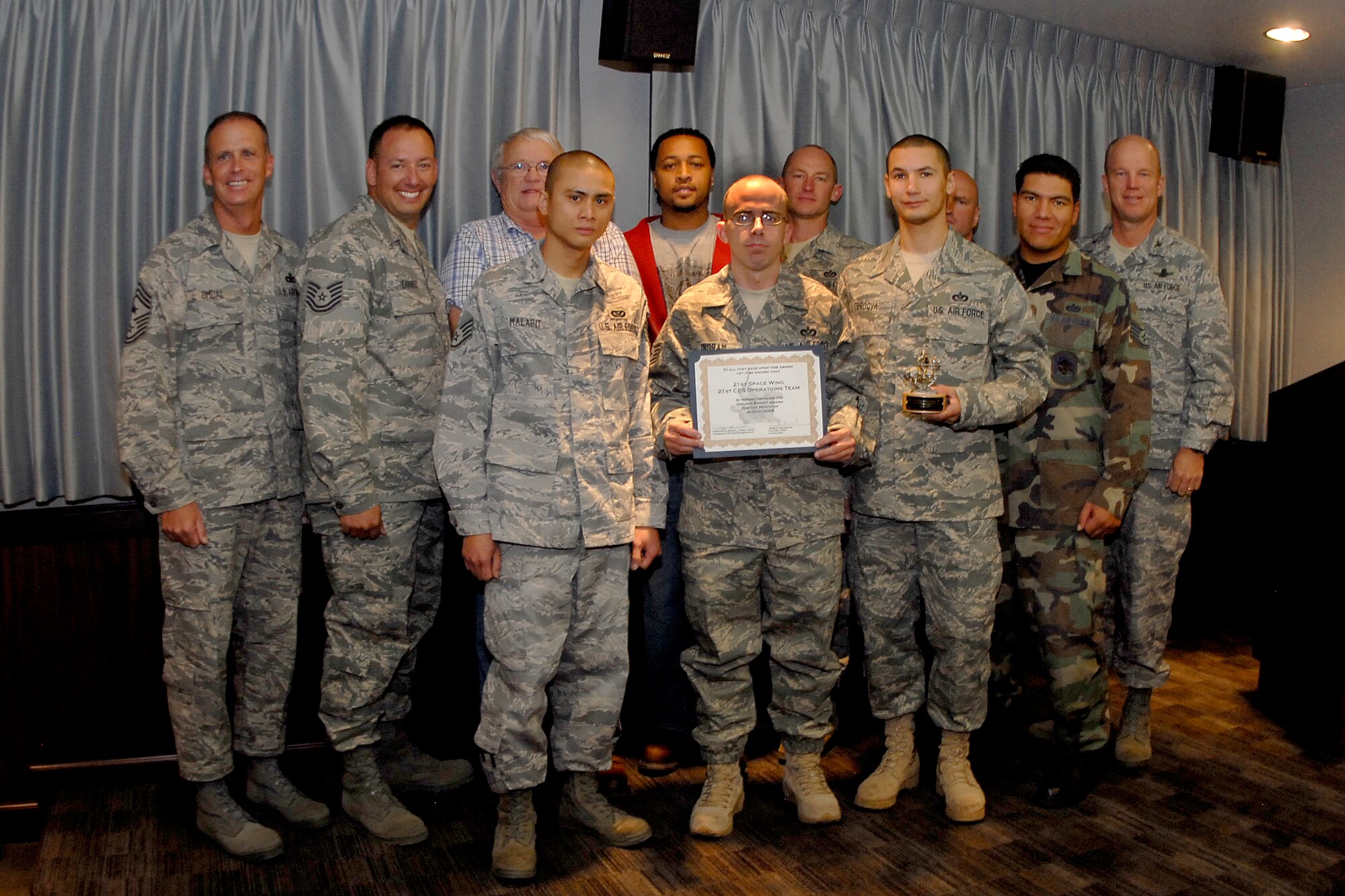 The August 2008 Golden Knight award is presented to the 21st Civil Engineer Squadron for reapir work they performed on the NORAD/USNORTHCOM headquarters building after an electrical fire August 15. (Air Force photo/Rob Bussard)