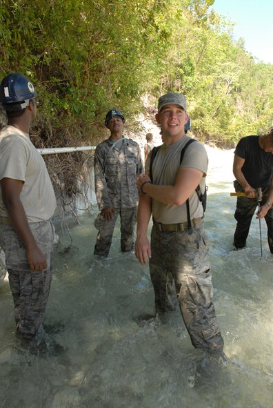 BAINET, Haiti -- Airmen from Minot Air Force Base's 5th Civil Engineer Squadron Prime Base Engineer Emergency Force and Navy Seabees, currently embarked aboard USS Kearsarge (LHD 3) in support of Continuing Promise 2008, reconstruct a water pipeline that was destroyed in recent storms. CP 2008 is a collaborative effort between the United States and partner militaries, non-governmental organizations, and partner-nation support organizations to build strong partnerships that can be called upon in the event of a regional situation requiring cooperative solutions. (U.S. Navy photo by Mass ?Communication Specialist 2nd Class (AW/SW) Gina Wollman)