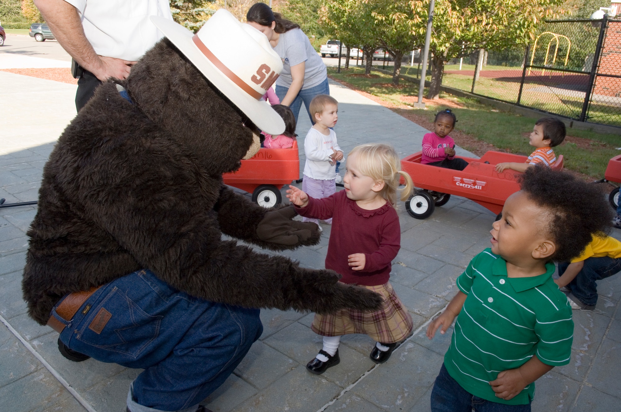 HANSCOM AFB, Mass. – Abby Herlihy (center) and Brendan Cochrane (right) visit with Smokey the Bear at the Child Development Center on Oct. 9. The Hanscom Fire Department visited the Child Development Center as well as other locations on base in celebration of Fire Prevention Week. (U.S. Air Force photo by Rick Berry)