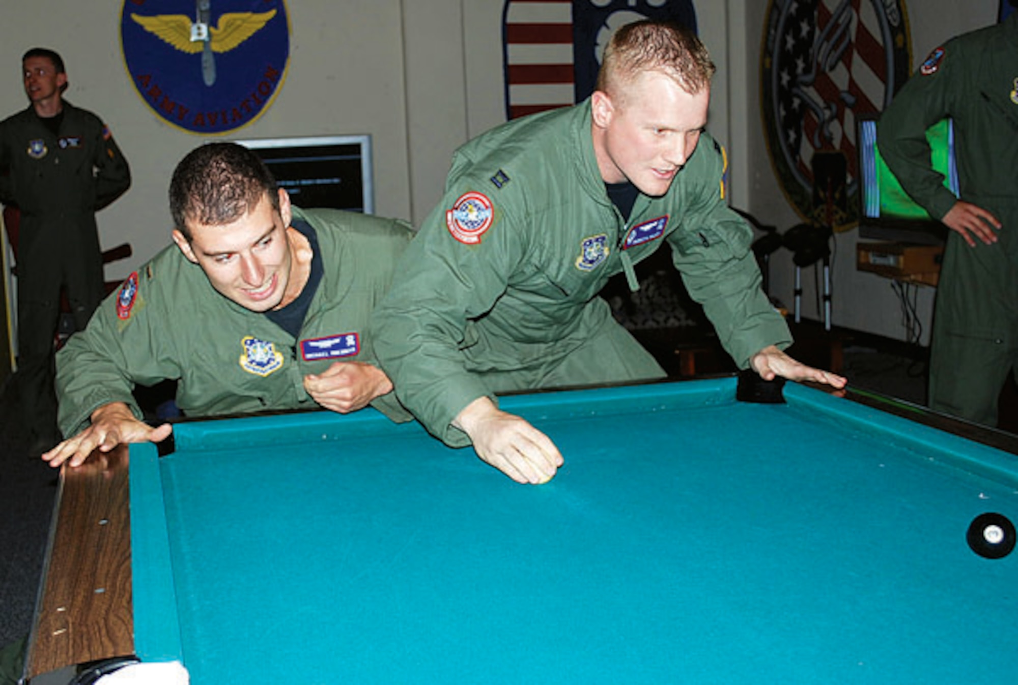 Second Lieutenant Michael Sherman and Capt. Burdette Millen, both from the 319th Missile Squadron, battle for control of the crud table during the grand opening of the Ground Zero Game Zone Oct. 3. Located in the basement of the Trail’s End Club, Ground Zero is open every Thursday and Friday at 4:30 p.m. and features various video games as well as crud and bar service. For more information call 773-3048.
