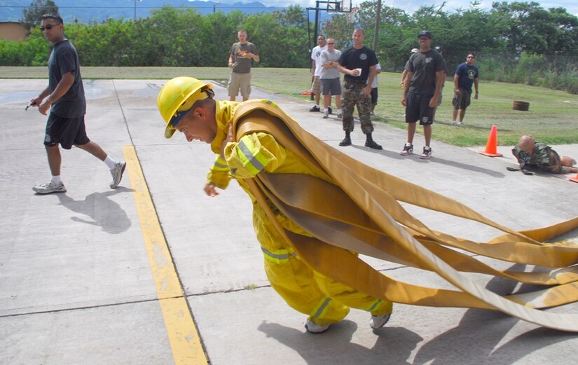 SOTO CANO AIR BASE, Honduras - Air Force Staff Sgt. John Steklachick, Joint Task Force-Bravo Army Forces, competes in the 4th Annual Soto Cano Fire Prevention Week Fire Muster. Six teams competed in events that consisted of basic fire fighter tasks. Sergeant Steklachick is deployed from Dyess Air Force Base. (U.S. Air Force photo by Staff Sgt. Joel Mease)