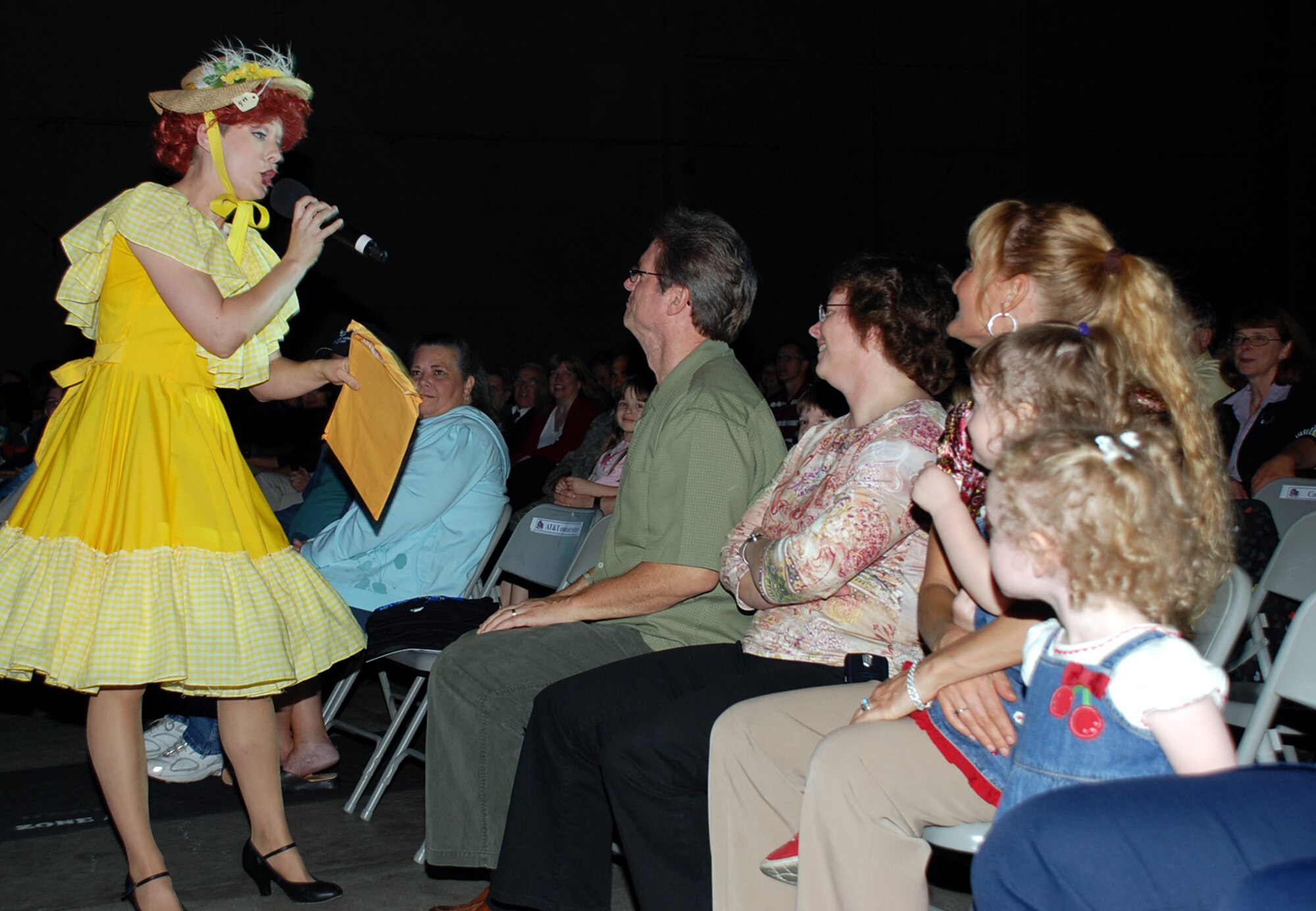 Senior Airman April Vollm, 39th Airlift Squadron, Dyess AFB, Texas, interacts with the audience during a comedic interlude in the Tops in Blue visit to McGuire Oct. 9. Airman Vollm is the only comedian in the 2008 Tops in Blue cast. (U.S. Air Force photo/Airman 1st Class Bekah Phy)