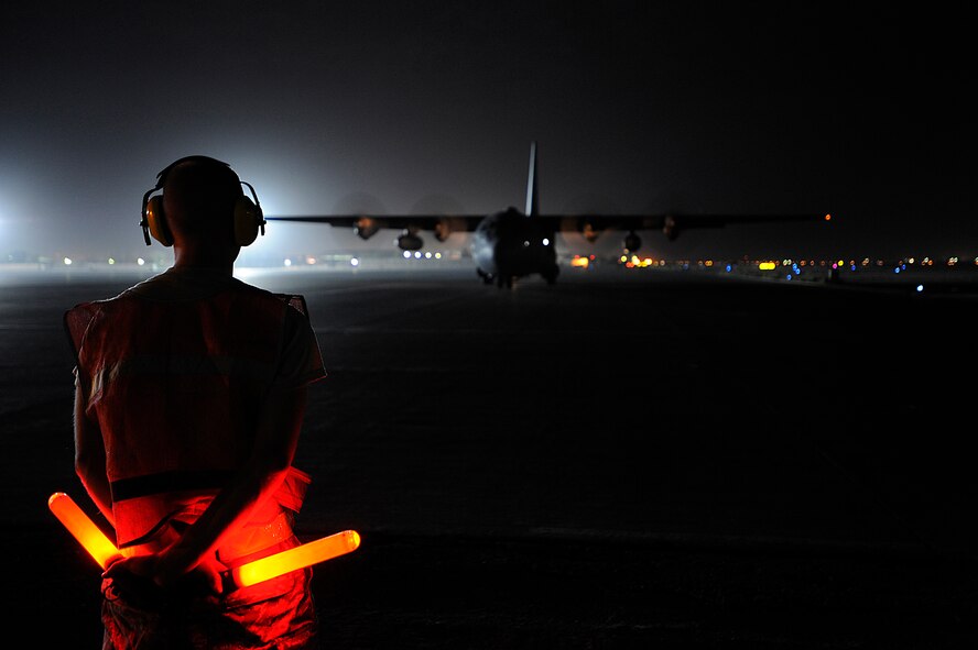 Senior Airman Luke Gills directs an Iraqi air force C-130 Hercules Oct. 11 at Joint Base Balad, Iraq. The aircraft, assigned to 23rd Squadron, was on a cargo resupply mission with members of the U.S. Air Force 370th Air Expeditionary Advisory Squadron. Airman Gills is a transient alert marshaller assigned to the 332nd Expeditionary Maintenance Squadron and deployed from Kirtland Air Force Base, N.M. His hometown is Fairfield, Pa. (U.S. Air Force photo/Airman 1st Class Jason Epley) 