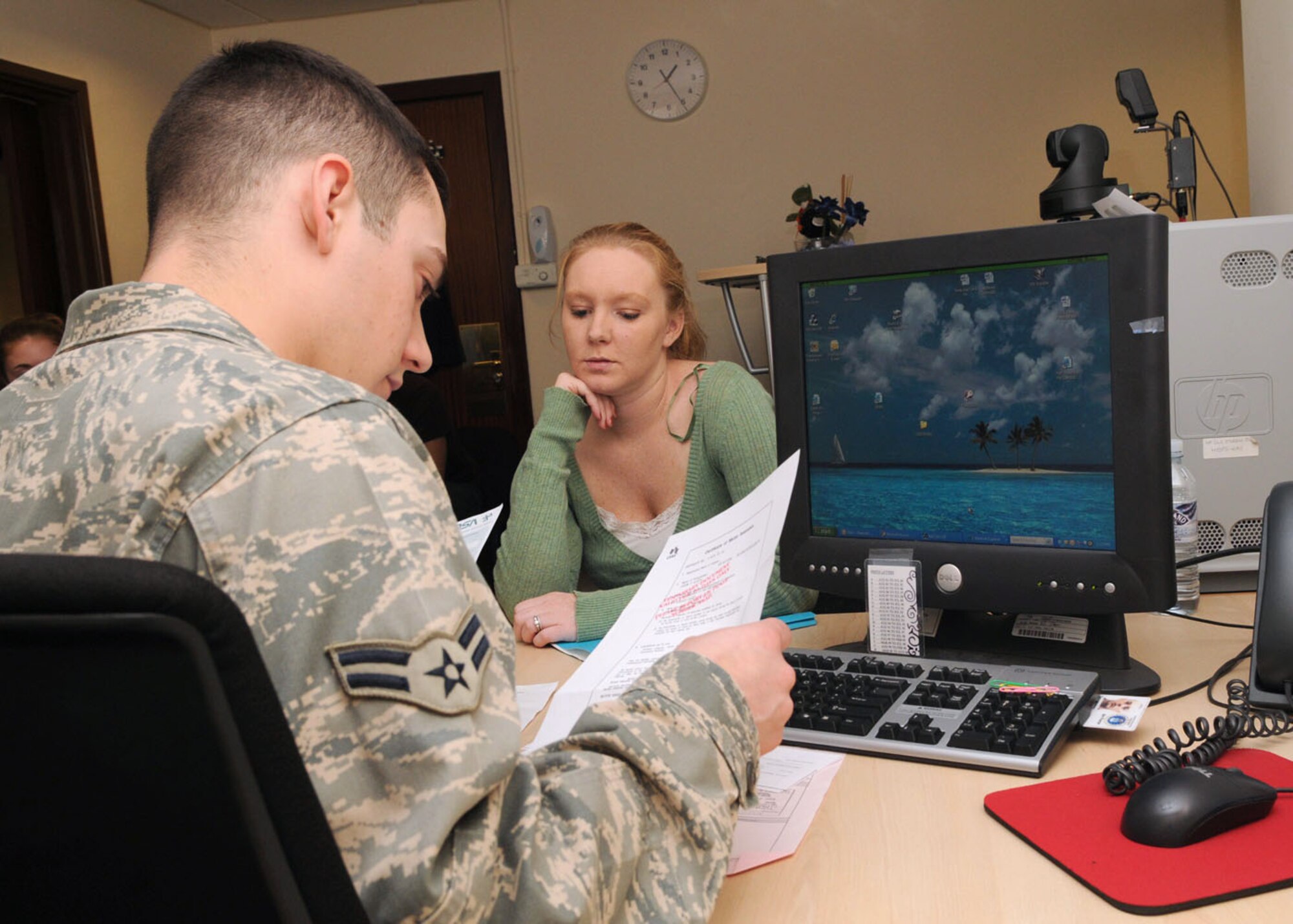 Airman 1st Class Colin Desormeaux from the 100th Security Forces Squadron Pass and ID section and Shawn Wirth, review vehicle registration paperwork Oct. 14, 2008 at RAF Mildenhall, England. The Security Forces Pass and ID section mainly deal with vehicle registration. They process more than 100 servicemembers and their families, Ministry Of Defence employees, and contractors weekly. (U.S. Air Force photo by Staff Sgt. Jerry Fleshman)