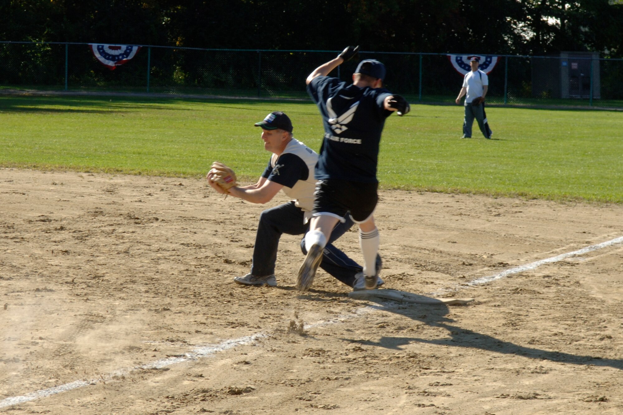 HANSCOM AFB, Mass. – Lt. Gen. Ted Bowlds (left), Electronic Systems Center commander, catches the ball at first base to record an out on Tech. Sgt. Mike Fisher during the Chiefs versus Eagles game on Oct. 10. The Chiefs went on to defeat the Eagles by a score of 8-5. (U.S. Air Force photo by Rick Berry)