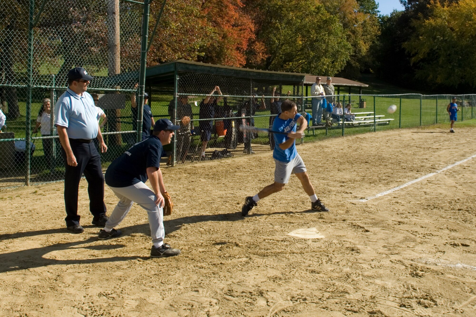 HANSCOM AFB, Mass. – Col. David Orr (right), 66th Air Base Wing commander, takes a swing at a pitch during the Eagles versus Chiefs softball game on Oct. 10, while Master Sgt. Mike Varno (center) catches for the Chiefs team. The Chiefs went on to win the game, and bragging rights, by a score of 8-5. (U.S. Air Force photo by Rick Berry)