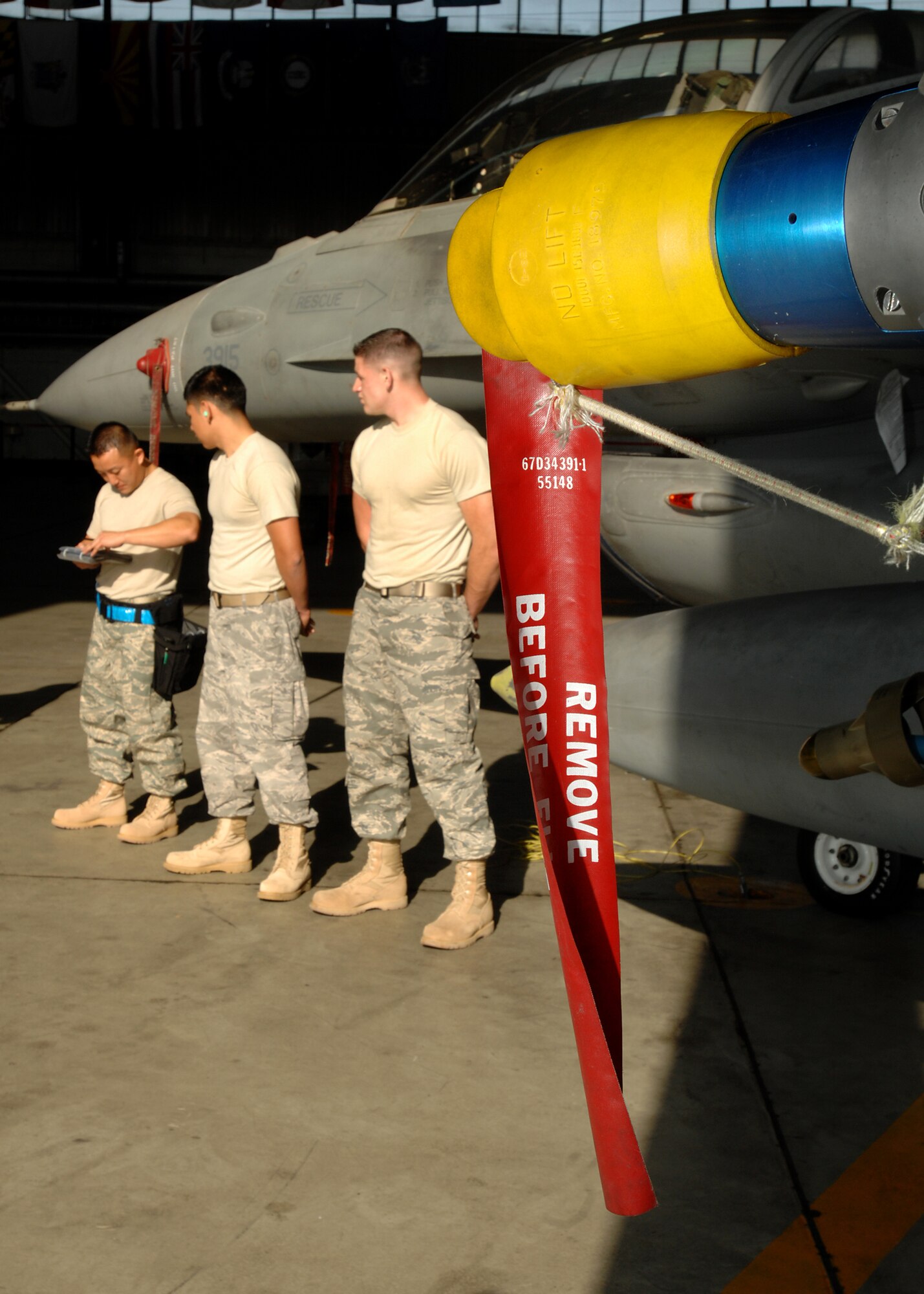 SPANGDAHLEM AIR BASE, Germany -- Staff Sgt. Joe Ly, Senior Airman Dean Martinez and Airman 1st Class William Beard, 23rd Aicraft Maintence Unit, review the weapons loading checklist Oct. 10, 2008. The 23rd AMU had the fastest load time in the competition. (U.S. Air Force photo by Airman 1st Class Nathanael Callon)