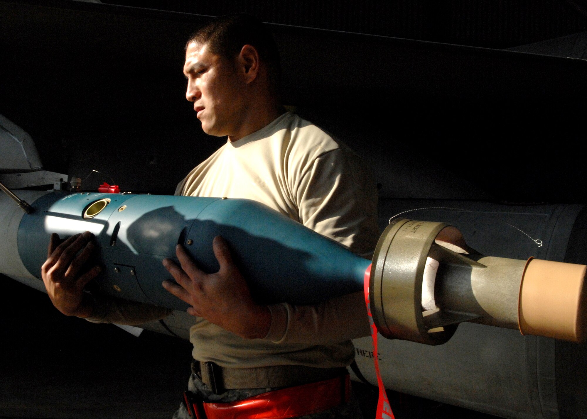 SPANGDAHLEM AIR BASE, Germany -- Staff Sgt. Dennis Escobar, 22nd Aircraft Maintenance Unit, inspects a missile on an F-16 Fighting Falcon during the weapons load contest at Spangdahlem Air Base on Oct. 10, 2008.  During the weapons load competition, aircraft maintenance crews compete at loading munitions in timed contests. (U.S. Air Force photo by Airman 1st Class Nicholas Wilson)