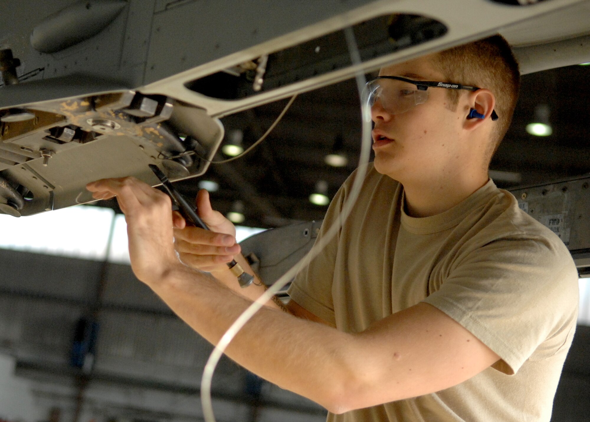 SPANGDAHLEM AIR BASE, Germany -- Airman 1st Class Sean Almond, 22nd Aircraft Maintenance Unit, pre-inspects an F-16 Fighting Falcon before loading munitions during the weapons load contest at Spangdahlem Air Base on Oct. 10, 2008.  During the weapons load competition, aircraft maintenance crews compete at loading munitions in timed contests. (U.S. Air Force photo by Airman 1st Class Nicholas Wilson)