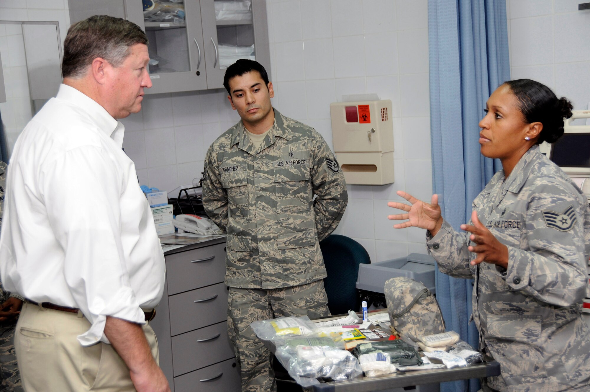 Staff Sgt. Lizeth Cameron (right) briefs Secretary of the Air Force Michael B. Donley on the individual first aid kit recertification process Oct. 11 at an air base in Southwest Asia. Sergeant Cameron described how members of the 379th Expeditionary Medical Groupand the 379th Expeditionary Logistics Readiness Squadron team together to inspect, replenish and distribute IFAKs for the entire U.S. Air Forces Central area of responsibility. Sergeant Cameron is assigned to the 379th Expeditionary Medical Group. (U.S. Air Force photo/Tech. Sgt. Michael Boquette) 
