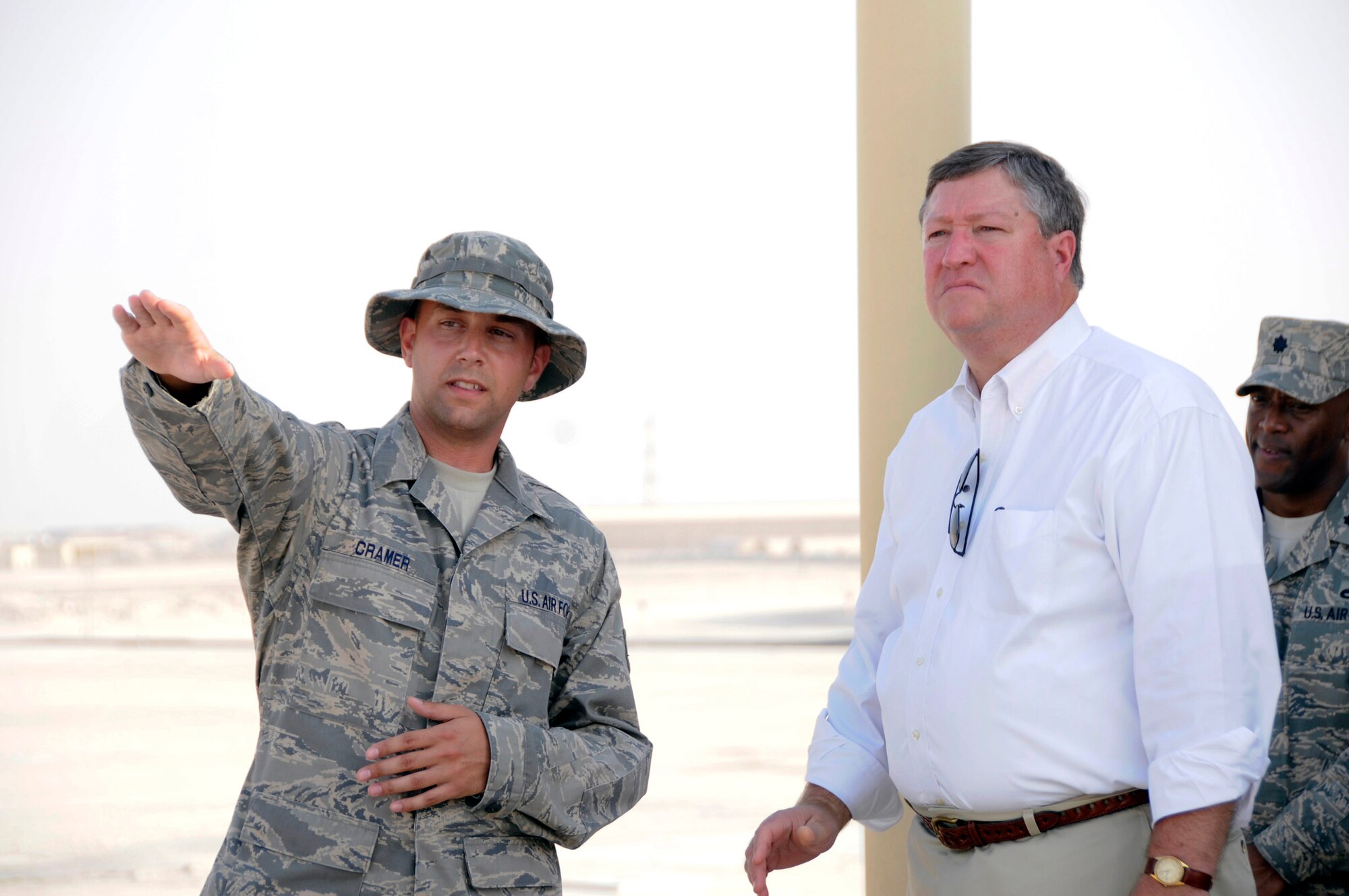 Staff Sgt. Matthew Cramer points out to Secretary of the Air Force Michael B. Donley different fuels areas and describes how fuels procedures are transitioning from expeditionary to enduring operations at the 379th Air Expeditionary Wing Oct. 11 at an air base in Southwest Asia. Sergeant Cramer is assigned to the 379th Expeditionary Logistics Readiness Squadron. (U.S. Air Force photo/Tech. Sgt. Michael Boquette) 
