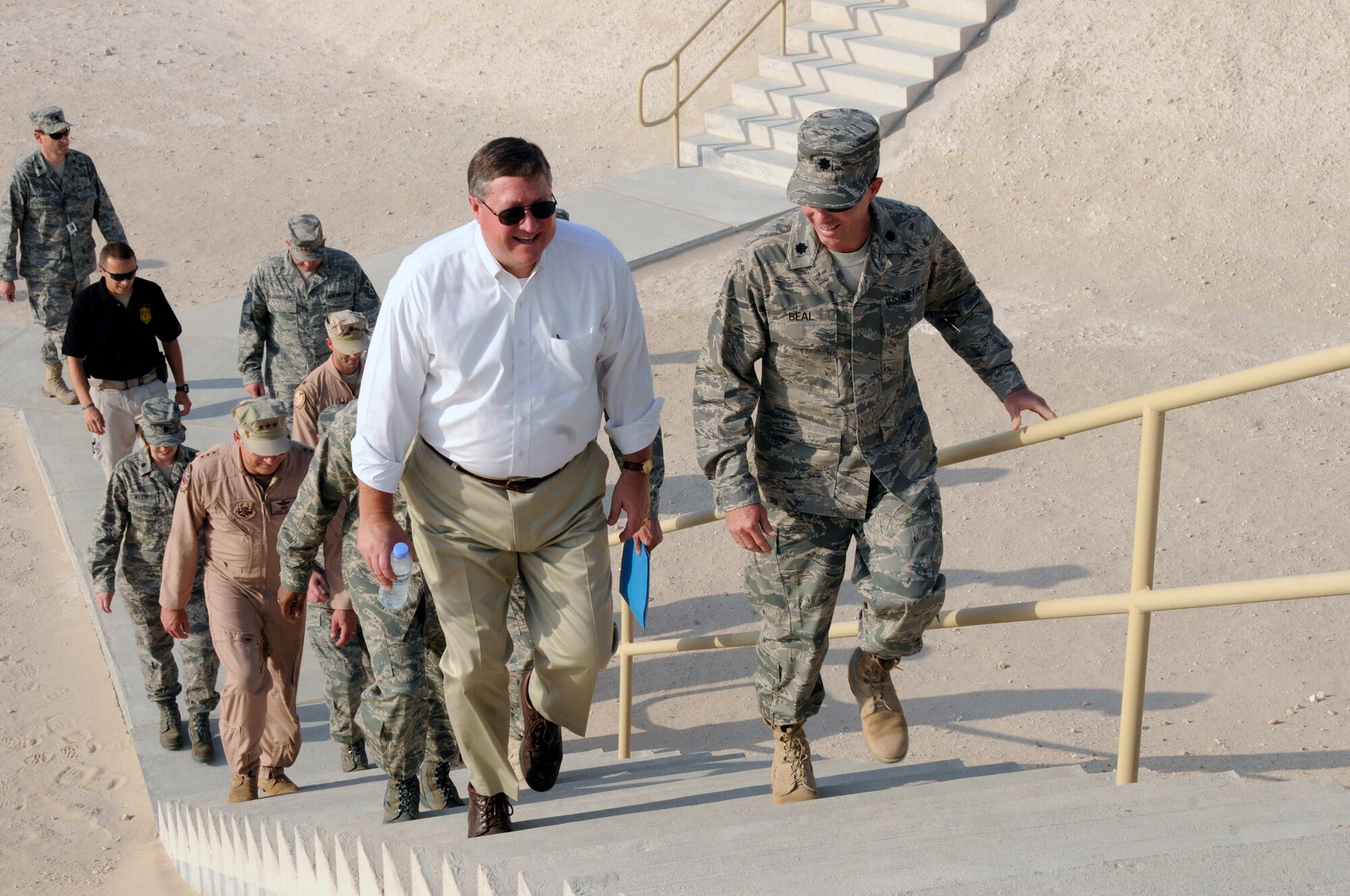 Lt. Col. Colin Beal (right) escorts Secretary of the Air Force Michael B. Donley to the top of a fuel storage area Oct. 11 at a Southwest Asia air base. The secretary was briefed on ongoing and future construction projects at the base. Colonel Beal is the commander of the 379th Expeditionary Logistics Readiness Squadron. (U.S. Air Force photo/Tech. Sgt. Michael Boquette) 

