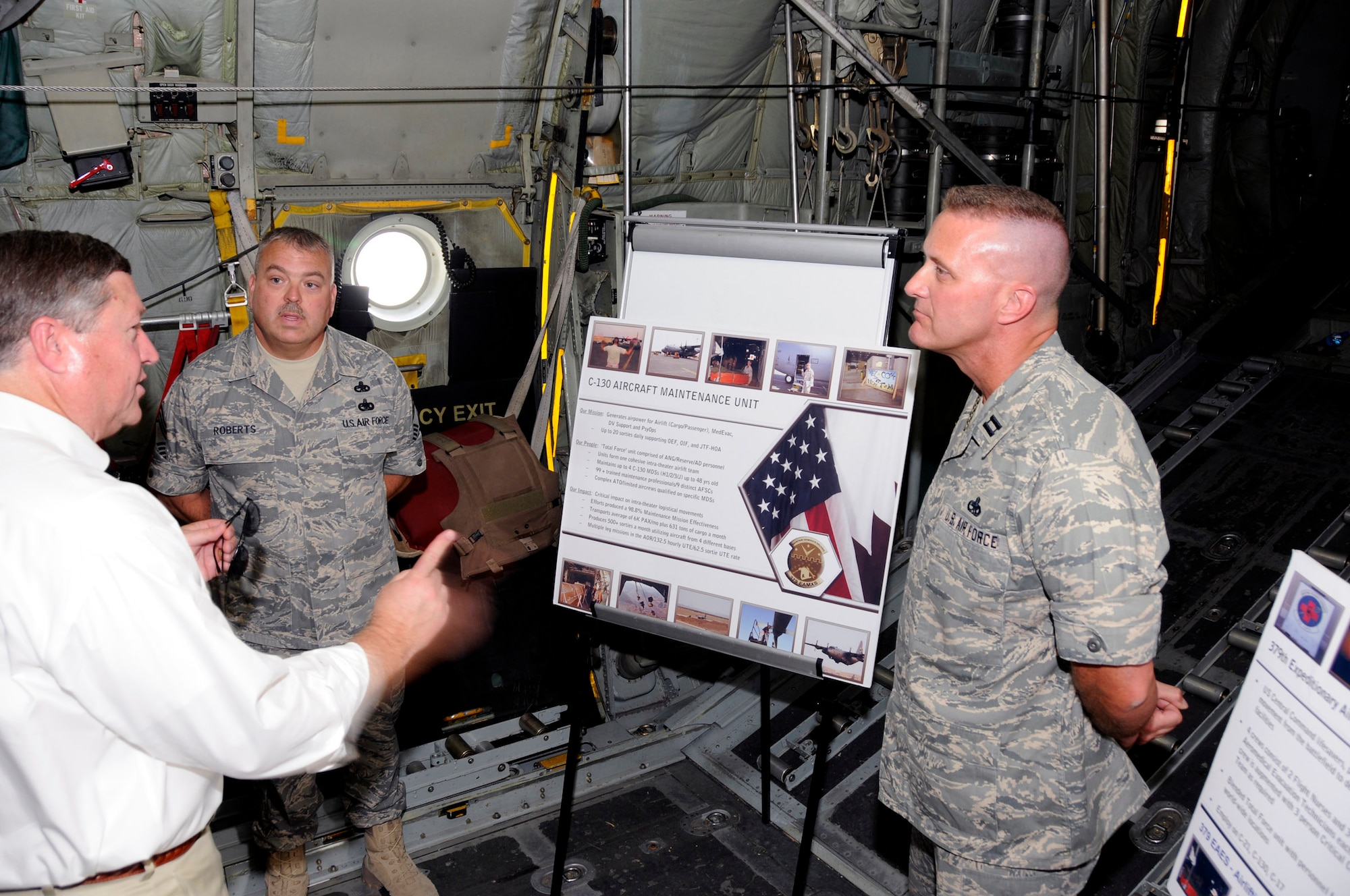 Secretary of the Air Force Michael B. Donley discusses C-130 Hercules maintenance issues with Capt. Collen Shelton and Chief Master Sgt. Donald Roberts Oct. 11 at a Southwest Asia air base. Captain Shelton and Chief Roberts are assigned to the both assigned to the 379th Expeditionary Aircraft Maintenance Squadron. (U.S. Air Force photo/Tech. Sgt. Michael Boquette) 

