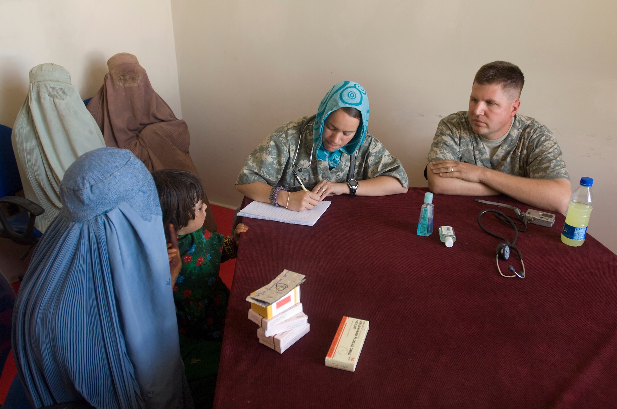 QALAT, Afghanistan -- Senior Airman Felicita Torres-Perkins and Capt. (Dr.) James Arnold,  both from the Zabul Provincial Reconstruction Team, take a patient's history Woman's Village Medical Outreach visit. The Zabul PRT medics treated a variety of problems ranging from headaches due to dehydration and stomach aches caused by worms and unhealthy water. Dr. Arnold is a family practice doctor deployed from Anderson Air Force Base, Guam. Airman Torres-Perkins, is a PRT/combat medic deployed from McGuire Air Force Base, N.J. (U.S. Air Force photo/Master Sgt. Keith Brown)