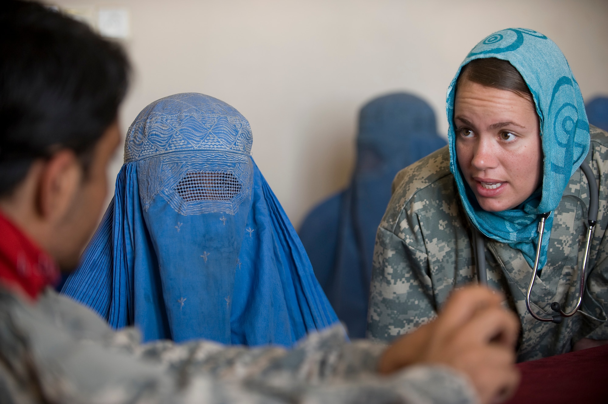 QALAT, Afghanistan -- Senior Airman Felicita Torres-Perkins, asks an Afghan women questions through an interpreter during a Women's Village Medical Outreach visit. The Zabul Provincial Reconstruction Team medics treated a variety of problems ranging from headaches due to dehydration and stomach aches caused by worms and unhealthy water. Airman Torres-Perkins, is a PRT/combat medic deployed from McGuire Air Force Base, N.J. (U.S. Air Force photo/Master Sgt. Keith Brown)
