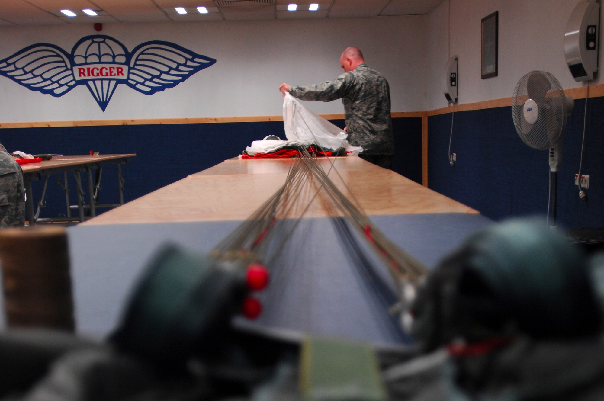 Senior Airman Michael Bryant, 86th Operations Support Squadron aircrew flight equipment, inspects and re-packs a parachute, Ramstein Air Base, Germany, Sept. 23, 2008. Airman Bryant ensures aircraft at Ramstein Air Base are equipped with sufficient emergency contingency equipment before each aircraft mission. (U.S. Air Force photo by Airman 1st Class Kenny Holston)(Released)