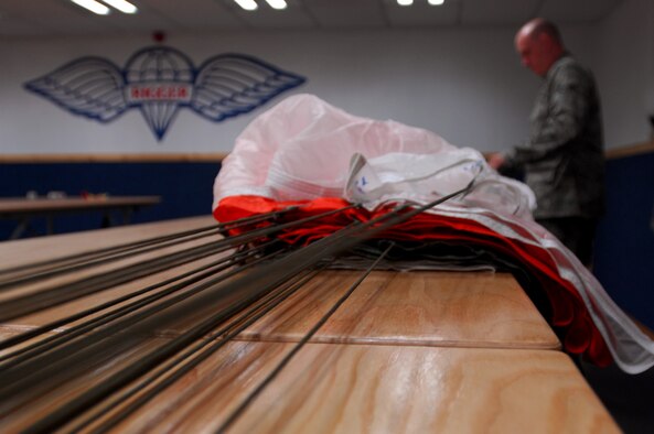 Senior Airman Michael Bryant, 86th Operations Support Squadron aircrew flight equipment, inspects and re-packs a parachute, Ramstein Air Base, Germany, Sept. 23, 2008. Airman Bryant ensures aircraft at Ramstein Air Base are equipped with sufficient emergency contingency equipment before each aircraft mission. (U.S. Air Force photo by Airman 1st Class Kenny Holston)(Released)