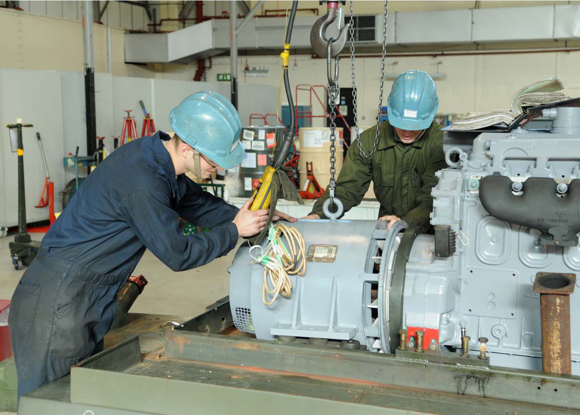 Senior Airman John Netzel and Tech. Sgt. Mike Ross, 100th Maintenance Squadron aerospace ground equipment technicians, install a new generator for an AN/M32A-86D which provides electrical power to an aircraft on Oct. 9, 2008, at RAF Mildenhall, England. Aerospace ground equipment section takes care of all scheduled inspections, maintenance repairs, and overall serviceability of each individual piece of powered and non-powered AGE equipment. (U.S. Air Force photo by Staff Sgt. Jerry Fleshman)