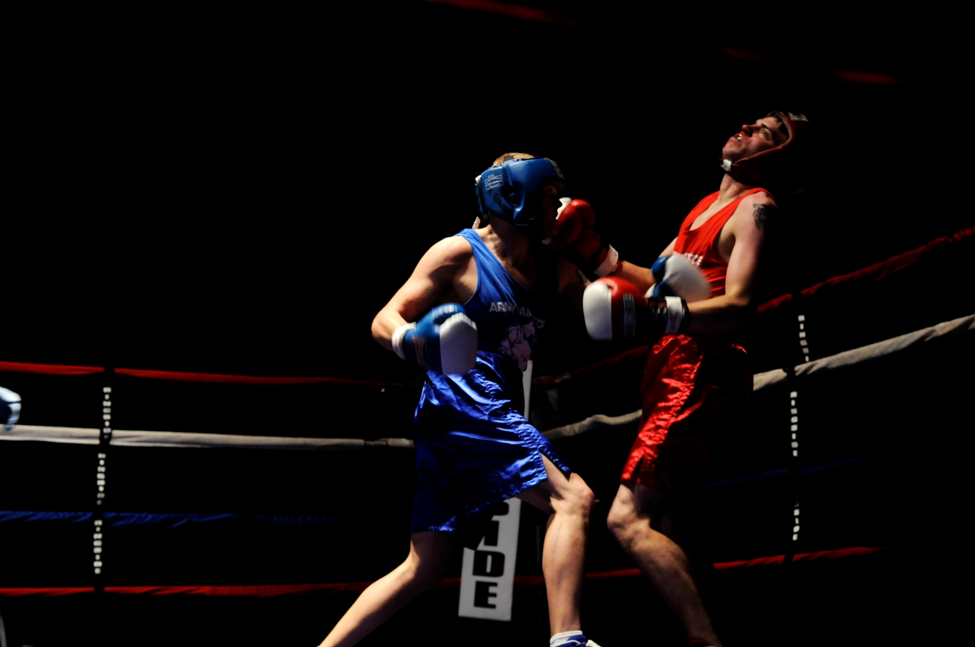 United States Air Force 2nd Lt. Phil Menagh (blue trunks), 435th Aerospace Medical Squadron, Ramstein Air Base, boxes against Airman 1st Class Matthew Tubbs (red trunks), 21st Operations Weather Squadron, Sembach Annex, in a boxing match, Vogelweh Air Base, Germany. U.S. Air Force 2nd Lt. Menagh defeated Airman 1st Class Tubbs. (U.S. Air Force photo by Staff Sgt. Sarayuth Pinthong)(Released)