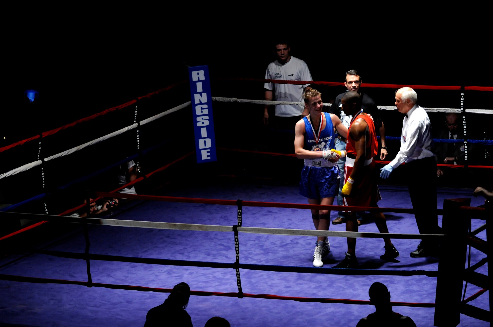 Denis Heier (blue trunks), a German boxer from the Turngemeinde Boxing Club, shakes a friendly had after defeating U.S. Air Force Staff Sgt. Harold Davis (red trunks), 86th Maintenance Squadron, Ramstein Air Base, during a boxing match, Vogelweh Air Base, Germany, Oct. 11, 2008. (U.S. Air Force photo by Staff Sgt. Sarayuth Pinthong)(Released)