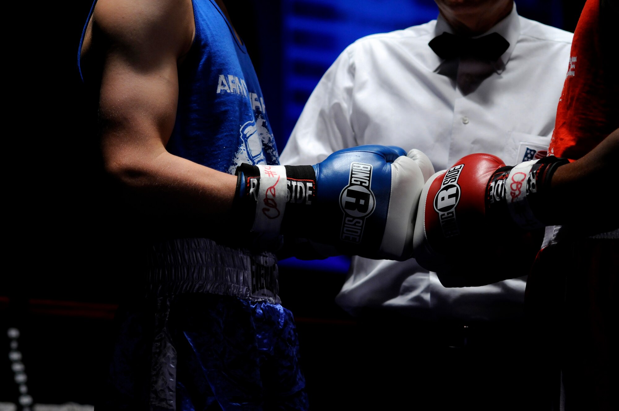 Denis Heier (blue trunks), a German boxer from the Turngemeinde Boxing Club, touches gloves with U.S. Air Force Staff Sgt. Harold Davis (red trunks), 86th Maintenance Squadron, Ramstein Air Base, during a boxing match, Vogelweh Air Base, Germany, Oct. 11, 2008. (U.S. Air Force photo by Staff Sgt. Sarayuth Pinthong)(Released)
