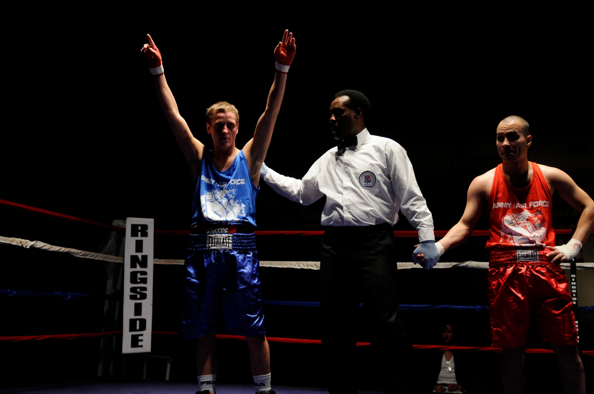 Vitali Frei (blue trunks), a German boxer from the Turngemeinde Worms Boxing Club, raises his arms in victory after defeating U.S. Army Pfc. Abel Ortegon (red trunks), Aurvey Division, Shape, Belgium, Vogelweh Air Base, Germany, Oct. 11, 2008. (U.S. Air Force photo by Staff Sgt. Sarayuth Pinthong)(Released)