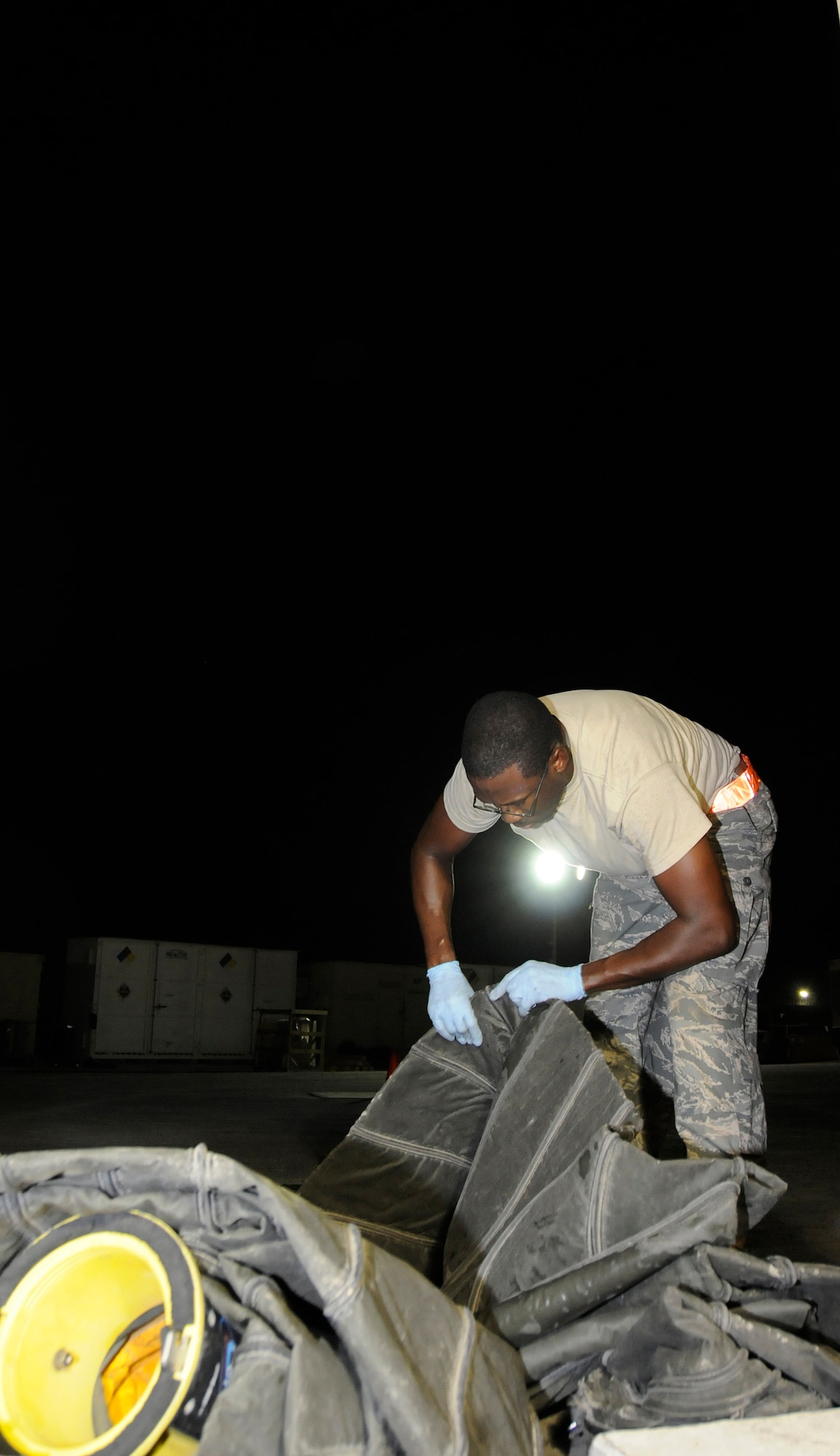 Senior Airman Scott Johnson, 379th Expeditionary Aircraft Maintenance Squadron, Aerospace Ground Equipment shop, performs a compliance inspection on air conditioning ducts, October 13, 2008, at an undisclosed air base in Southwest Asia.  Airman Johnson checks the ducts as part of a phase 2 inspection on an air conditioning and heating unit.  A phase 2 is an in-depth inspection checking each system on the unit, including changing out all filters and fluids.  In the desert heat, air conditioning units are mission essential because without them aircraft components would overheat during pre-flight operation checks.  Airman Johnson is a native of Warner Robins, Ga., and is deployed from Kadena Air Base, Japan, in support of Operations Iraqi and Enduring Freedom and Joint Task Force-Horn of Africa.  (U.S. Air Force photos by Tech. Sgt. Michael Boquette/Released)