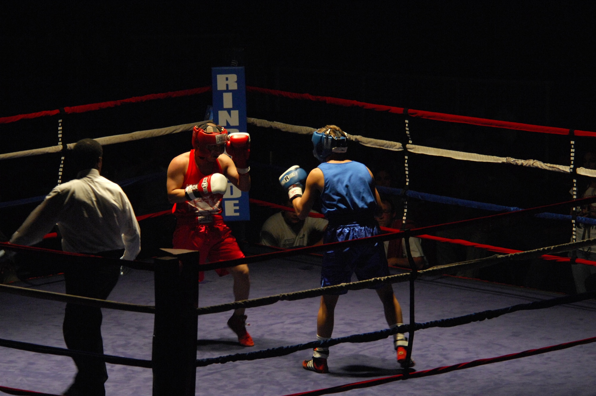 United States Army Pfc. Abel Ortgun (red trunks), Aurvey Division, Shape, Belgium, competes against German boxer Vitali Frei (blue trunks) from the Turngemeinde Worms Boxing Club, Vogelweh Air Base, Germany, Oct. 11, 2008. Frei won the match against Pfc. Ortgun. (U.S. Air Force photo by Airman 1st Class Kenny Holston)(Released)