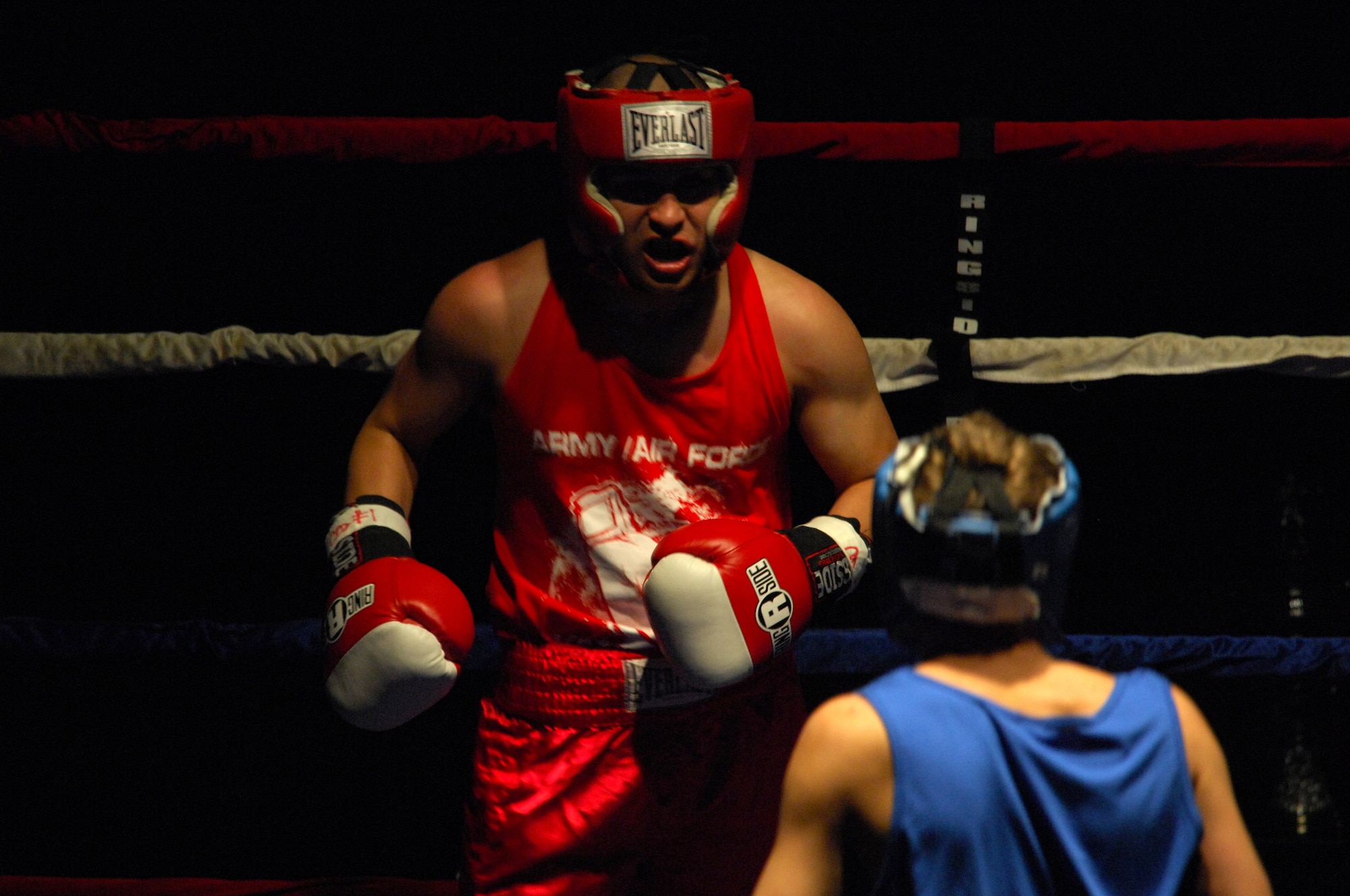 United States Army Pfc. Abel Ortgun (red trunks), Aurvey Division, Shape, Belgium, competes against German boxer Vitali Frei (blue trunks) from the Turngemeinde Worms Boxing Club, Vogelweh Air Base, Germany, Oct. 11, 2008. Frei won the match against Pfc. Ortgun. (U.S. Air Force photo by Airman 1st Class Kenny Holston)(Released)