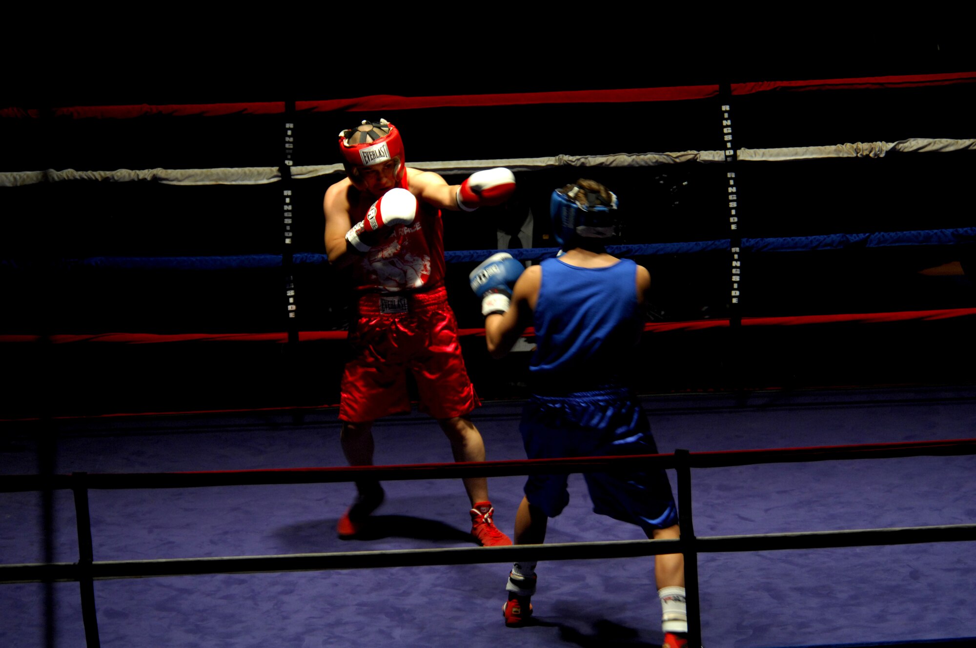 United States Army Pfc. Abel Ortgun (red trunks), Aurvey Division, Shape, Belgium, competes against German boxer Vitali Frei (blue trunks) from the Turngemeinde Worms Boxing Club, Vogelweh Air Base, Germany, Oct. 11, 2008. Frei won the match against Pfc. Ortgun. (U.S. Air Force photo by Airman 1st Class Kenny Holston)(Released)
