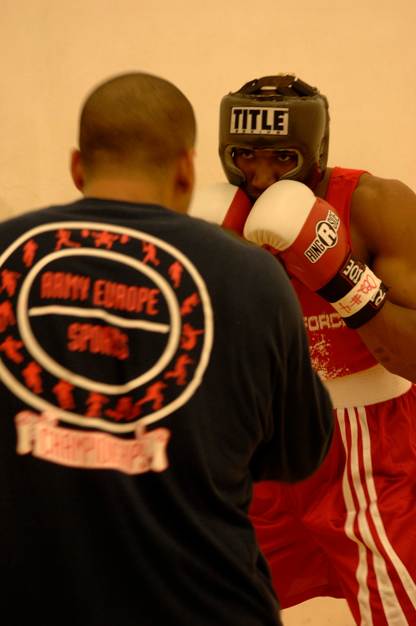United States Air Force Senior Airman David Meredith, 721st Aerial Port Squadron, helps Staff Sgt. Harold Davis, 86th Maintenance Squadron, both from Ramstein Air Base, warm up prior to a boxing match, Vogelweh Air Base, Germany, Oct. 11, 2008. Staff Sgt. Davis lost his match against Denis Heier, a German boxer from the Turngemeinde Worms boxing club. (U.S. Air Force photo by Senior Airman Amber Bressler)(Released)