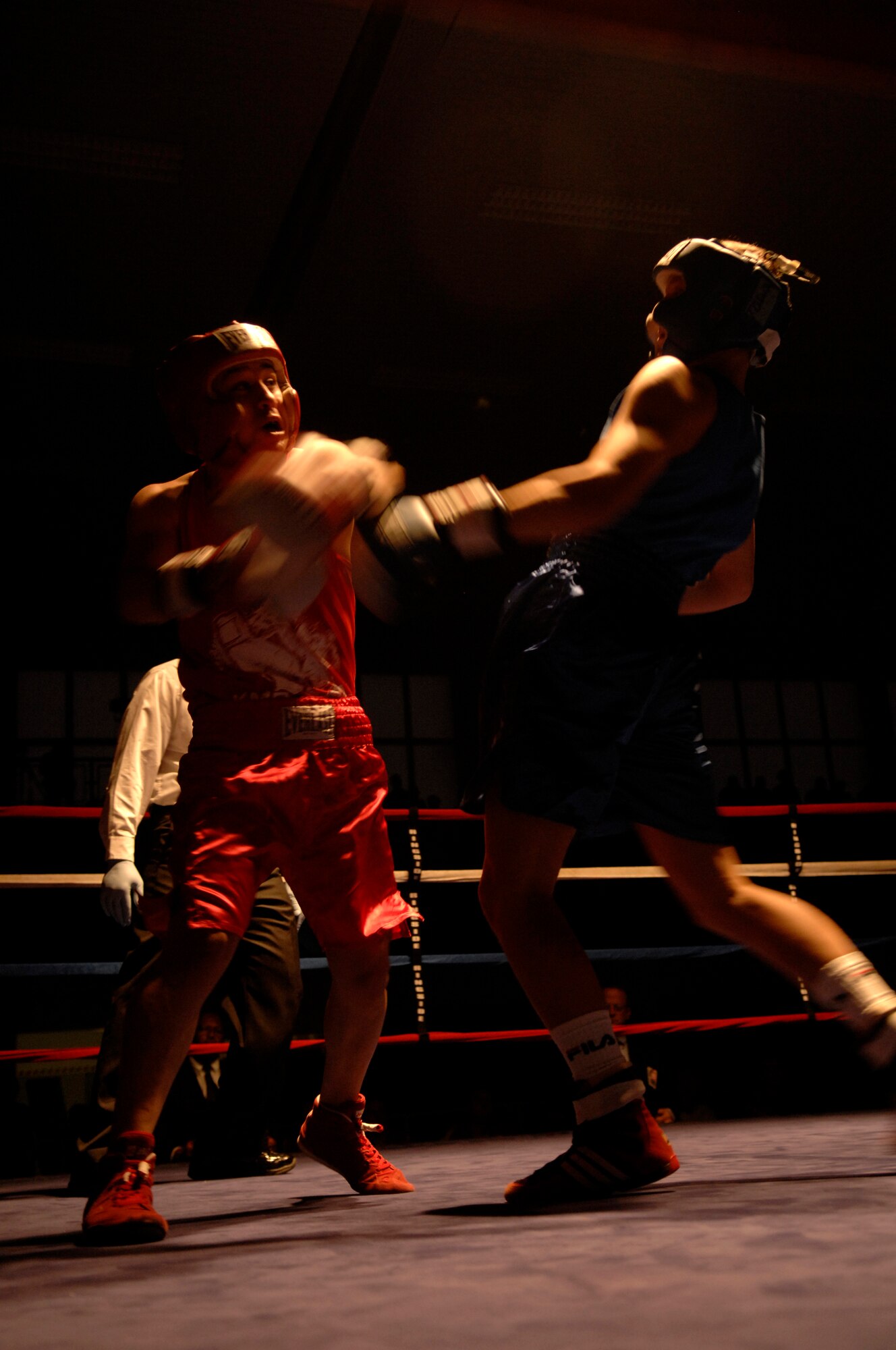 United States Army Pfc. Abel Ortgun (red trunks), Aurvey Division, Shape, Belgium, competes against German boxer Vitali Frei (blue trunks) from the Turngemeinde Worms Boxing Club, Vogelweh Air Base, Germany, Oct. 11, 2008. Frei won the match against Pfc. Ortgun. (U.S. Air Force photo by Senior Airman Amber Bressler)(Released)
