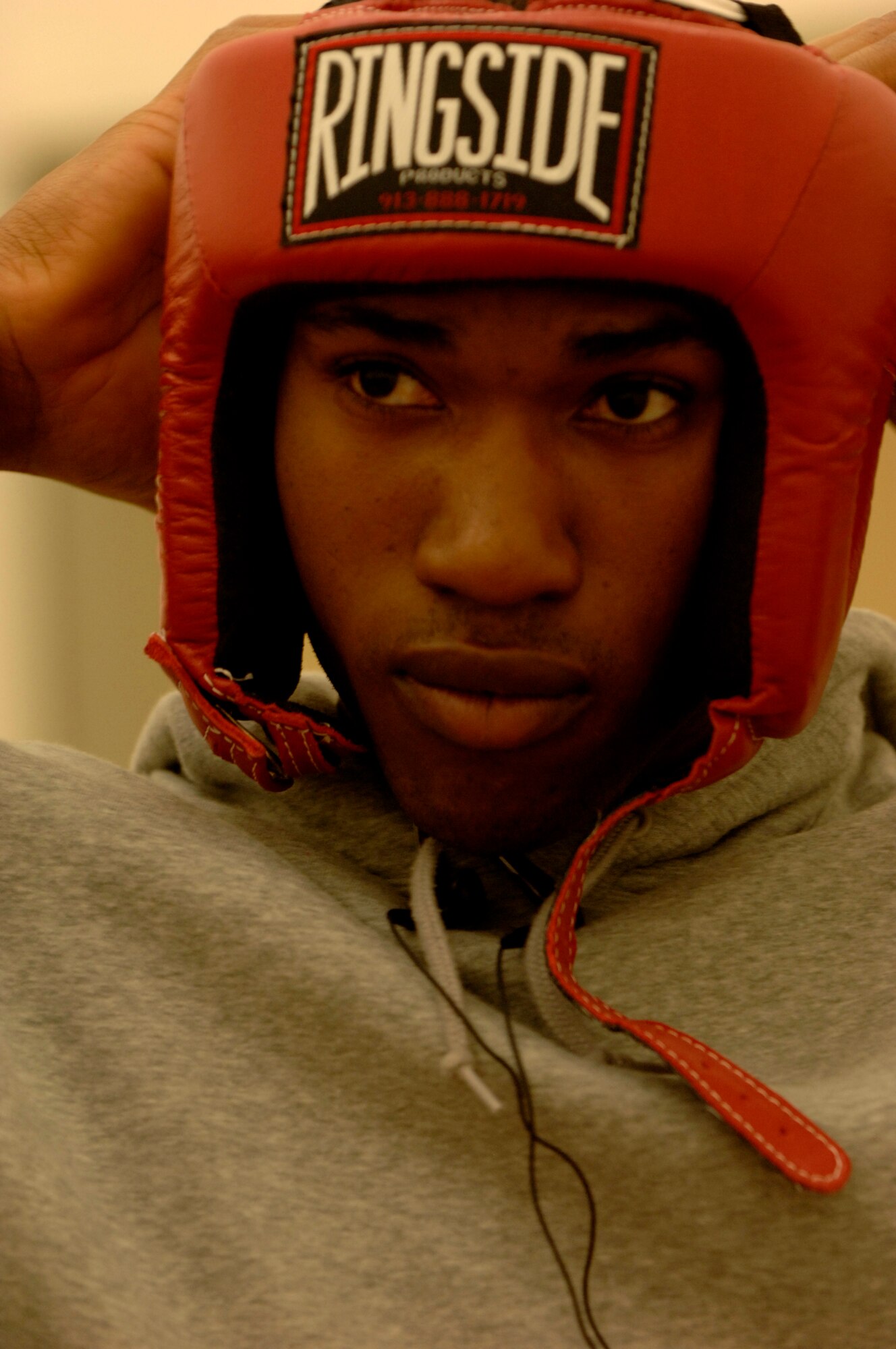 United States Air Force Staff Sgt. Harold Davis, 86th Maintenance Squadron, Ramstein Air Base, prepares his safety gear prior to his boxing match, Vogelweh Air Base, Germany, Oct. 11, 2008. Staff Sgt. Davis lost his match against Denis Heier, a German boxer from the Turngemeinde Worms boxing club. (U.S. Air Force photo by Senior Airman Amber Bressler)(Released)