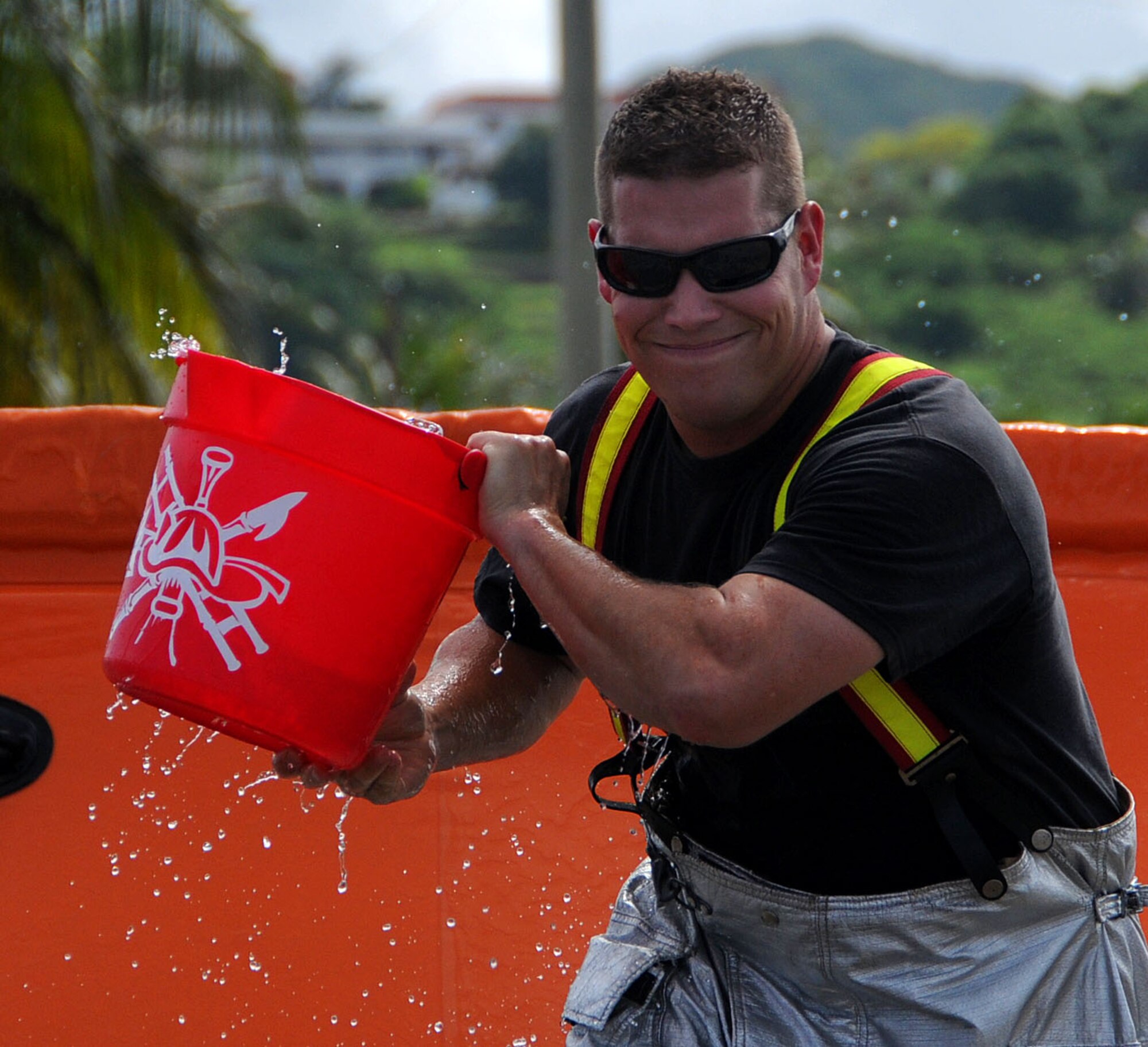 ANDERSEN AIR FORCE BASE, Guam - After filling his water pale,  Staff Sgt. Christopher Palkowetz runs toward his team during the Bucket Brigade at the 2008 Guam Fire Muster Competition at Paseo Park Oct. 12. Several other competitions took place including an engine pull, firefighter relay, and water polo. (U.S. Air Force photo by Airman 1st Class Courtney Witt)