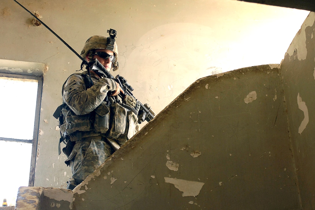 U.S. Army Spc. Jason Hardman searches a home while his unit patrols and clears the Owja Desert of Iraq, Oct. 10, 2008. 
