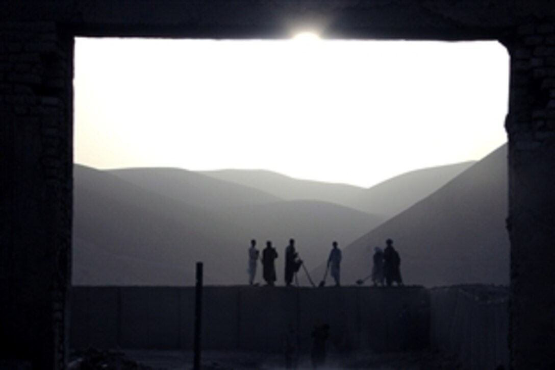 Local Afghan workers perform maintenance on the perimeter wall at International Security Assistance Force Forward Operating Base Bala Murghab, Afghanistan, Oct. 2, 2008. ISAF is assisting the Afghan government in extending and exercising its authority and influence across the country, creating the conditions for stabilization and reconstruction. 