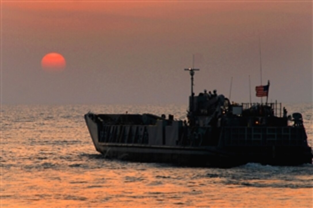 A landing craft utility assigned to Assault Craft Unit 4 maneuvers toward the amphibious dock landing ship USS Carter Hall near Kuwait, Oct. 12, 2008. Carter Hall is supporting maritime security operations in the U.S. 5th Fleet area of responsibility.