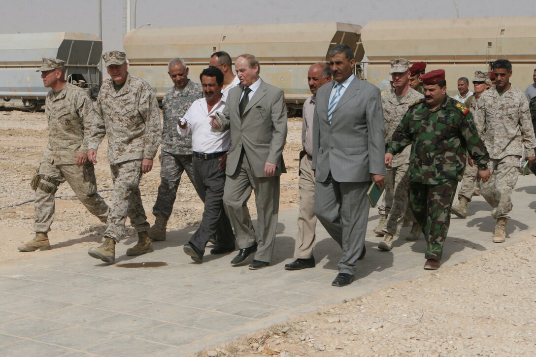 Major Gen. Martin Post, deputy commanding general, Multi National Force-West, tours Camp Al Qa'im, Iraq, Oct. 14, with Iraqi officials, railroad workers and Marines of Task Force 2nd Battalion, 2nd Marine Regiment, Regiment Combat Team 5.  The camp, which had been used by Coalition forces since 2003, was turned over to Iraqi officials and will once again be used as a train station.