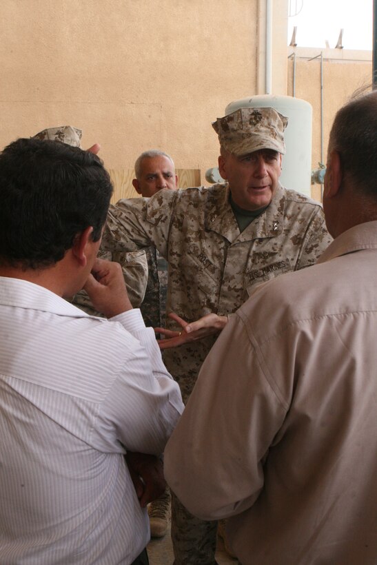 Maj. Gen. Martin Post, deputy commanding general, Multi National Force-West, fine-tunes the details of turning over Camp Al Qa'im, Iraq, a previous railroad station before 2003, to Iraqi officials Oct. 14. Through hard work of Iraqi railroad employees, the railway is expected to open again soon and support the local factories with their shipments of various items.