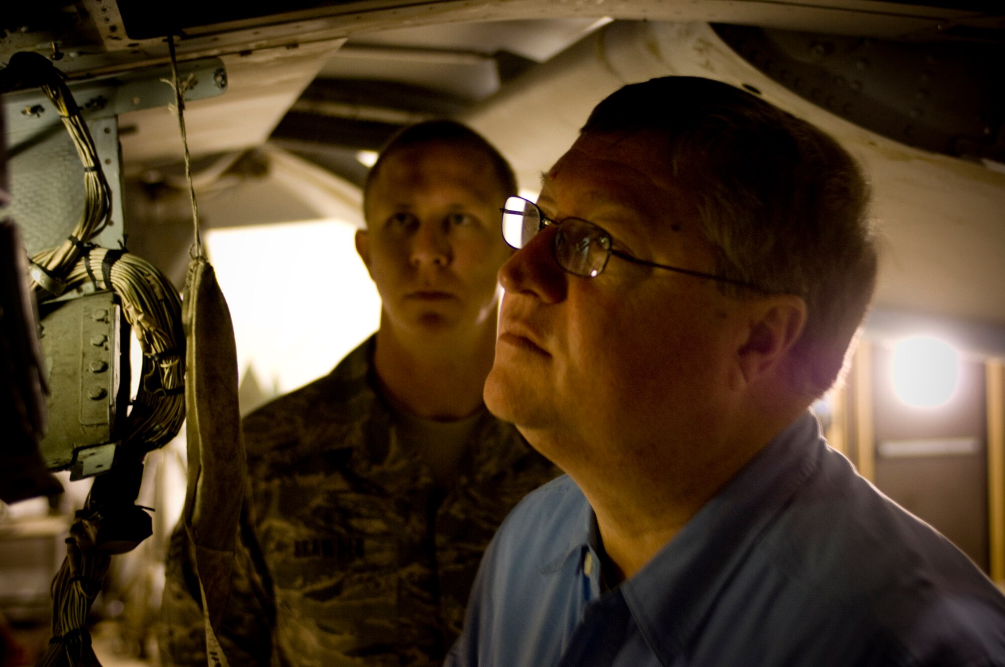 BAGRAM AIR FIELD, Afghanistan -- Secretary of the Air Force Michael Donley looks at the inner workings of an A-10 Thunderbolt II here Oct. 15. Secretary Donley met with the A-10 maintenance unit to better understand how the maintainers are keeping this aged bird in the fight. (U.S. Air Force photo by Staff Sgt. Samuel Morse/Released)