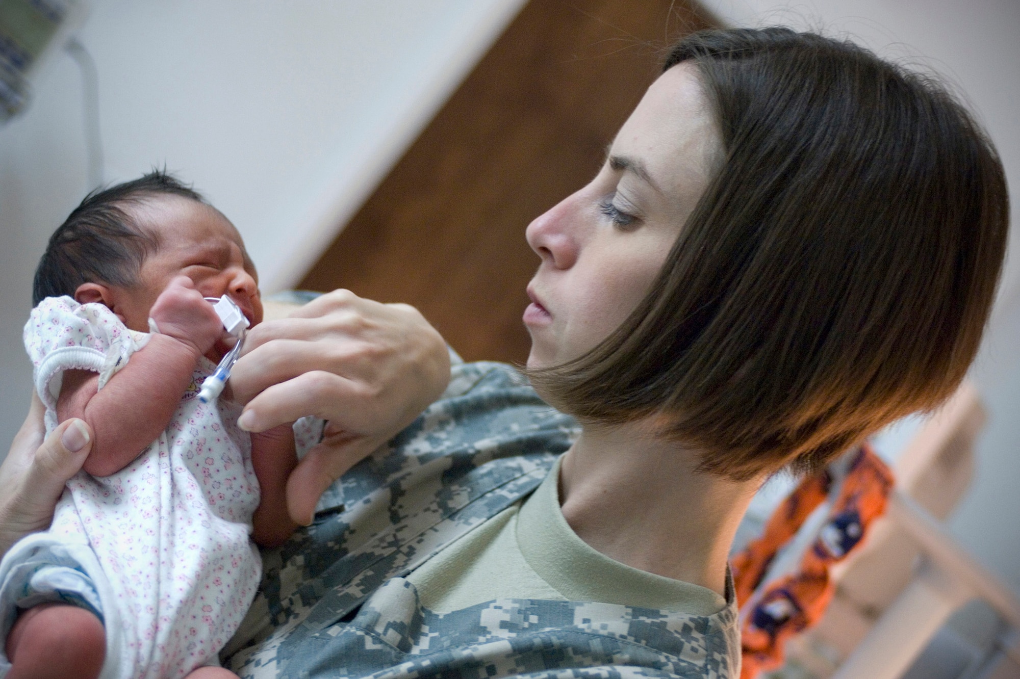 Intensive care unit nurse 1st Lt. Michelle Pierson, deployed from Travis Air Force Base, Calif., examines Zahra, the first Afghan baby born at Craig Joint Theater Hospital, Oct. 6 at Bagram Air Field, Afghanistan. Lacking a neonatal ward, intensive care unit nurses have taken on the role of watching after the newborn. (U.S. Air Force photo by Staff Sgt. Rachel Martinez)