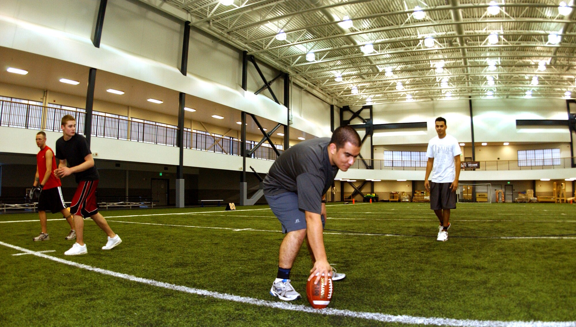 Airman Brandon Johnson, Airman 1st Class Michael Durgin, 2nd Lt. Daniel Mota, and Airman 1st Class Sayed Lutfi play football for their physical fitness at the Baker Field House fitness center Oct. 13, 2008 at Eielson Air Force Base, Alaska. The center recently added a new indoor football field, two indoor running tracks, and new exercise equipment to keep airman fit and boost morale during the long winter months. (U.S. Air Force photo by Airman Laura Max)