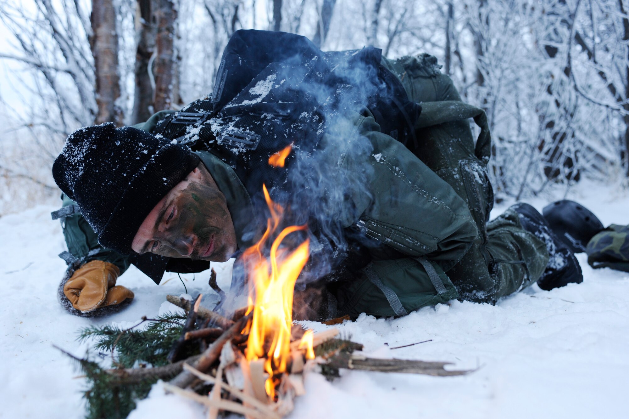 1st Lt. Matthew Feeman, 80th Fighter Squadron, Kunsan Air Base, Korea builds a fire to help combat the cold preventing frost bite and hypothermia during RED FLAG-Alaska 09-1 Oct. 14, 2008, at Eielson Air Force Base, Alaska. Lieutenant Feeman is playing the role of a pilot who was shot down behind enemy lines and he must now survive, evade, resist and escape to successfully complete the training mission.  (U.S. Air Force photo/Senior Airman Jonathan Snyder)
